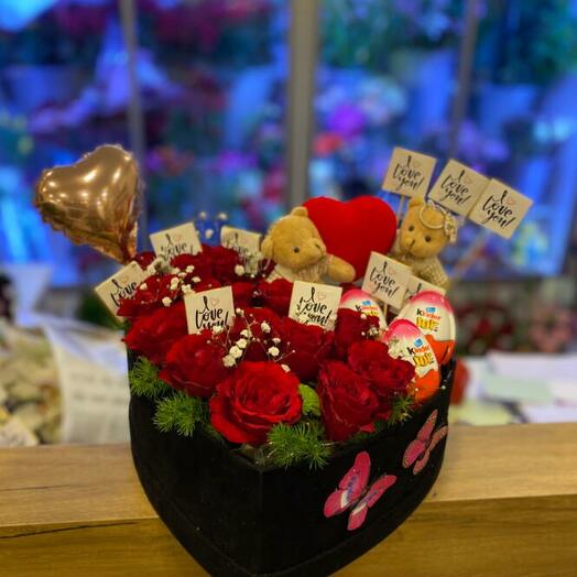 Red rose, chocolates and teddy bears in a black box