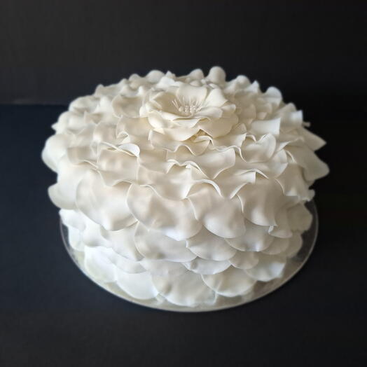 Cake decorated with fondant shaped like rose petals