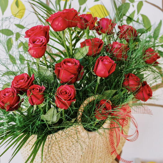 red rose in a straw bag